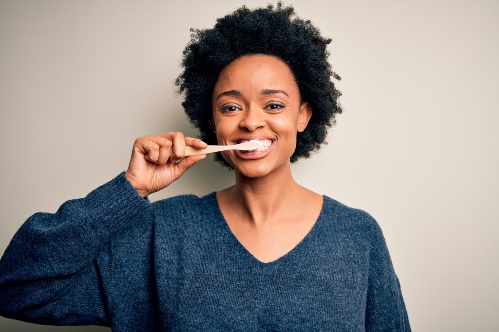 African,American,Woman,Brushing,Her,Teeth,Using,Tooth,Brush,And